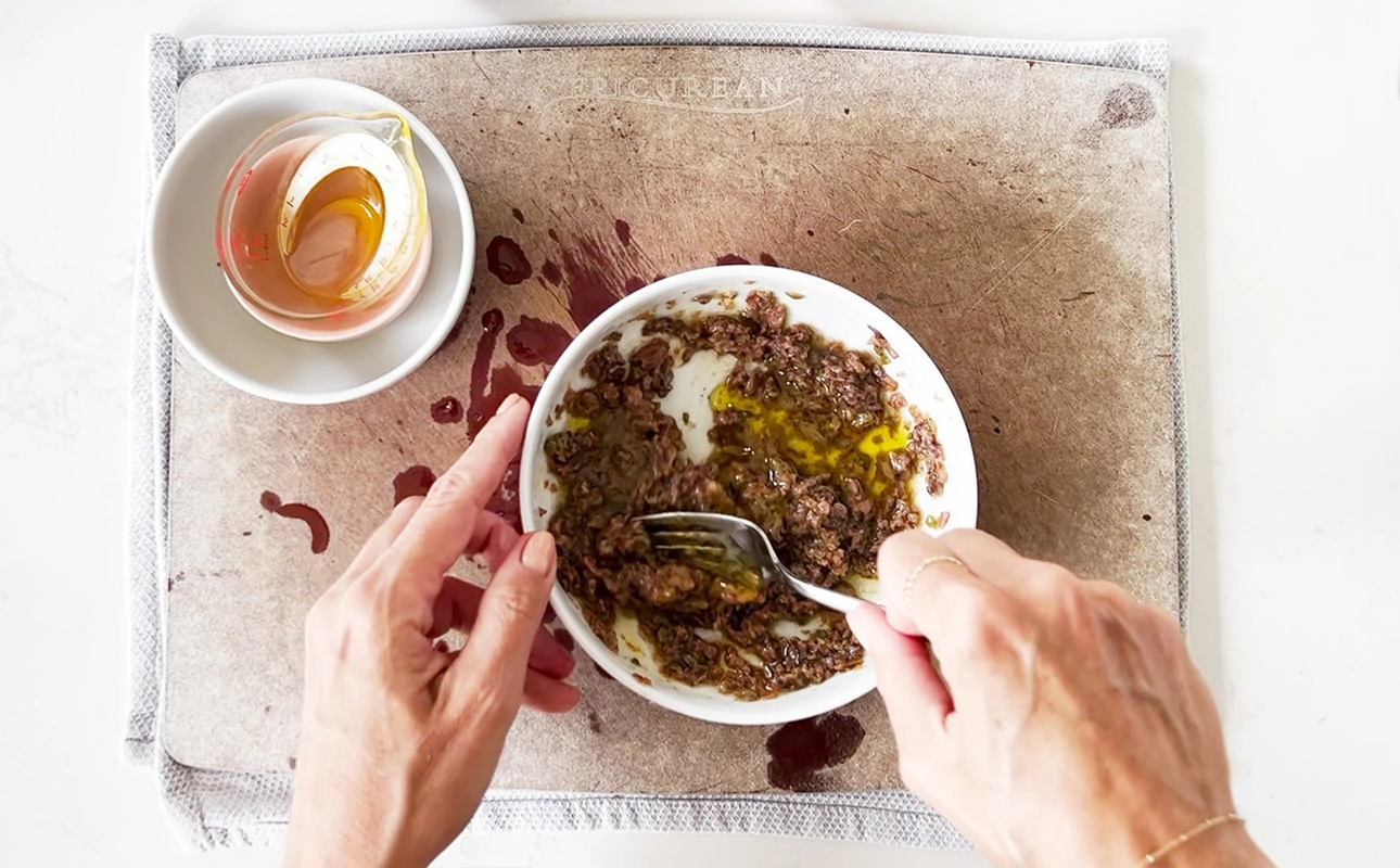 Making anchoïade, a dressing made with anchovies, olive oil, red wine vinegar, capers, and garlic // FoodNouveau.com