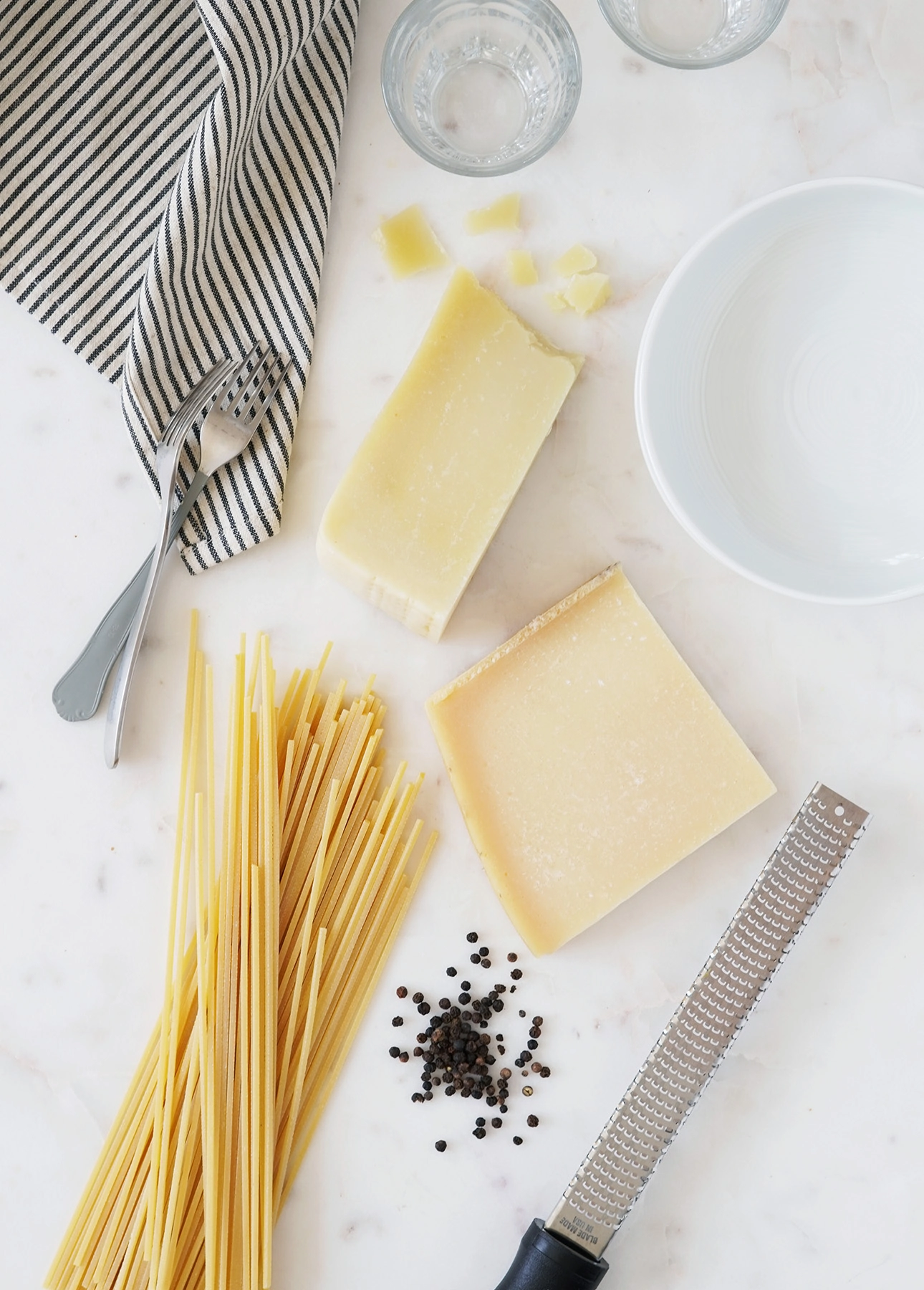 The basic ingredients required to make Cacio e Pepe: pasta, cheese, and black pepper // FoodNouveau.com