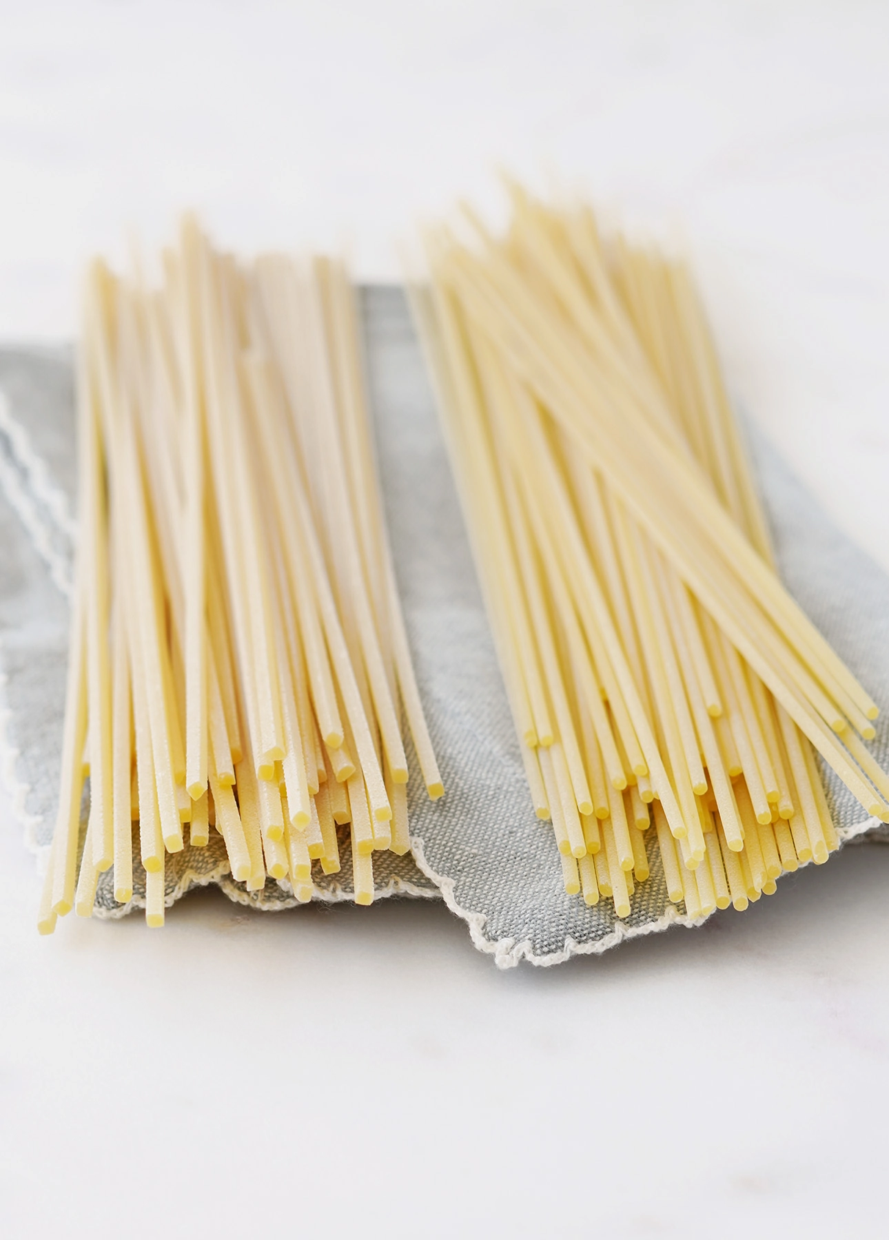 Spaghetti alla Chitarra (also called Tonnarelli) is the pasta that is traditionally used to make Cacio e Pepe. Here it is compared to regular spaghetti, on the right. // FoodNouveau.com