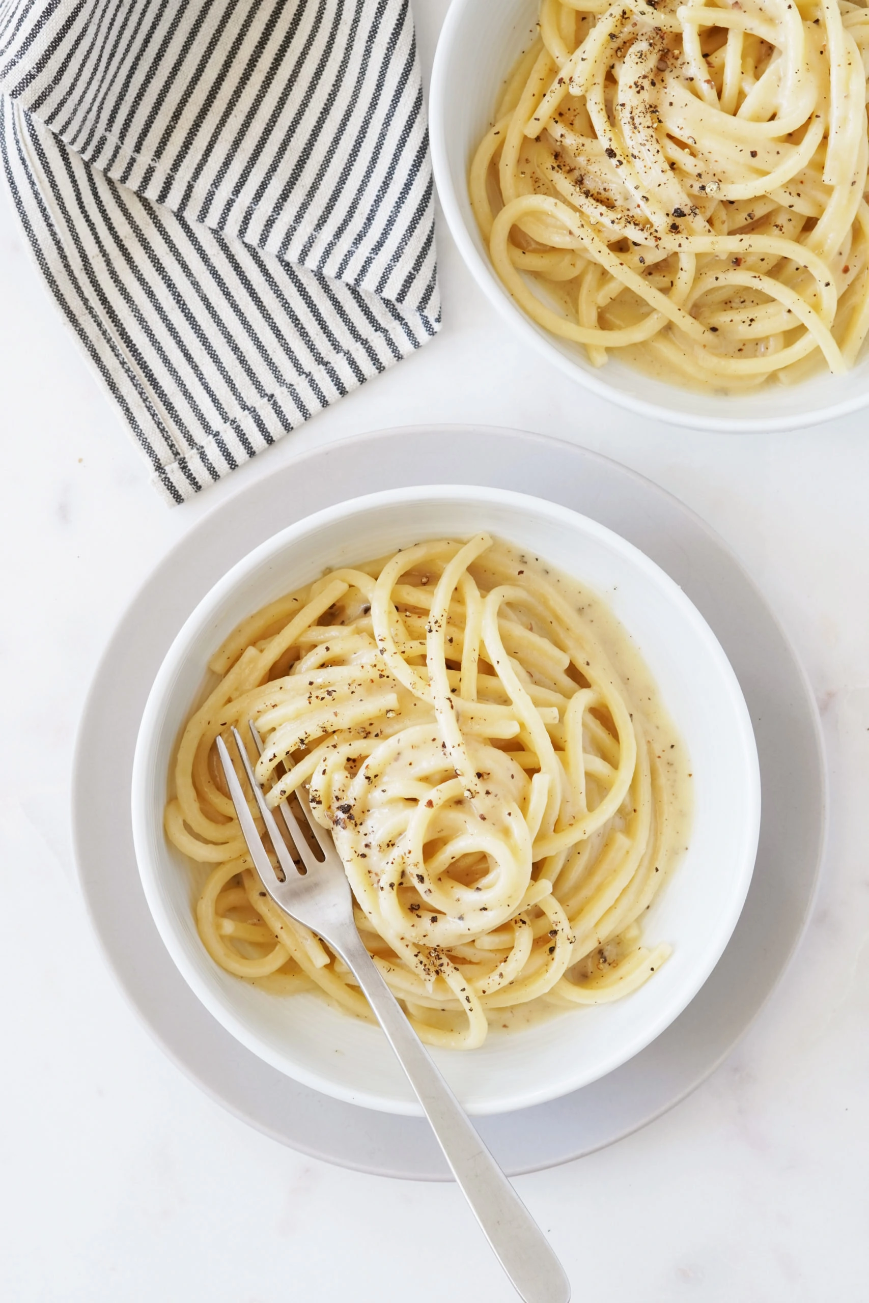 Servings of Cacio e Pepe pasta, a classic Roman dish // FoodNouveau.com