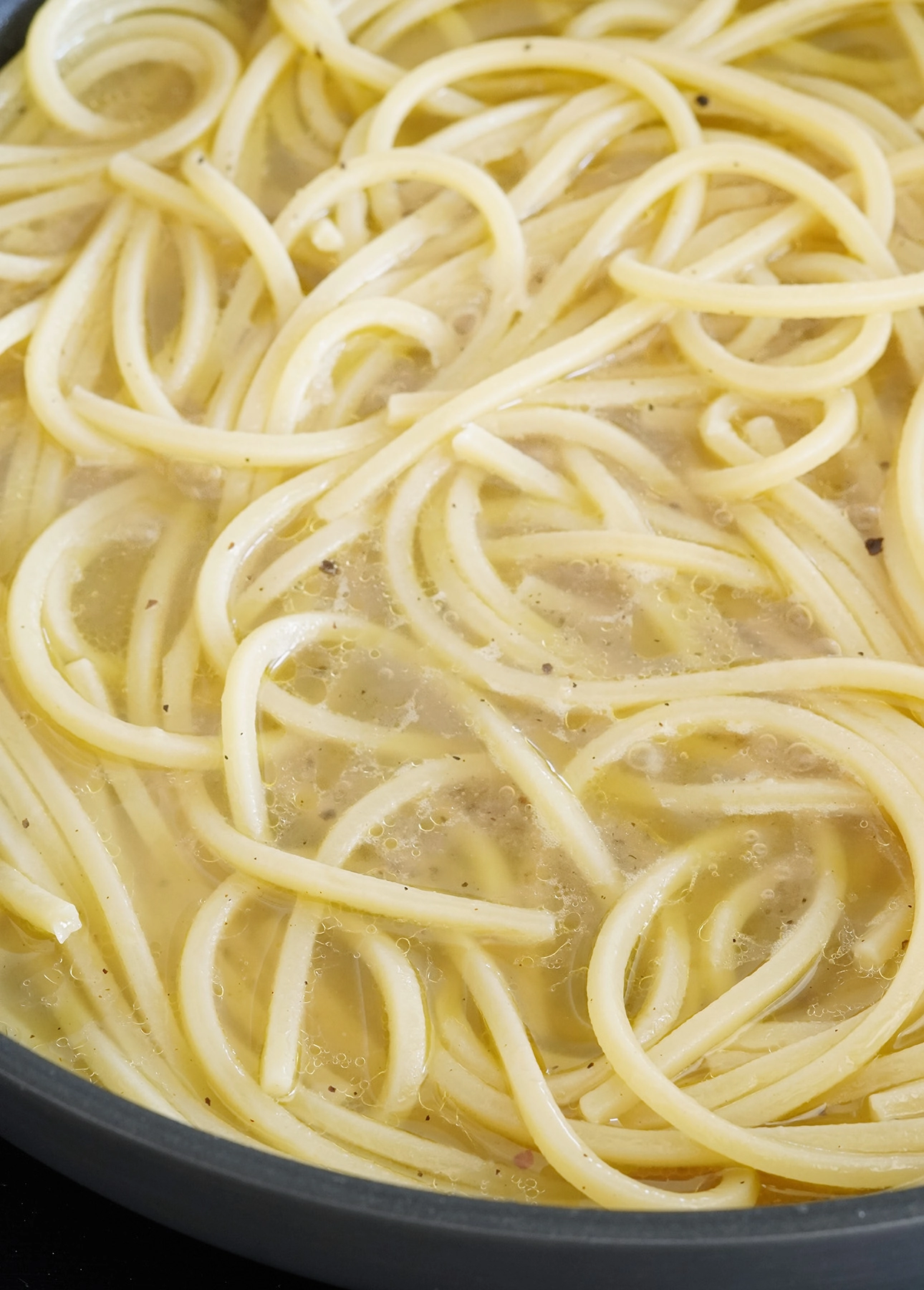 Starchy pasta cooking water is essential to make the creamiest Cacio e Pepe pasta // FoodNouveau.com